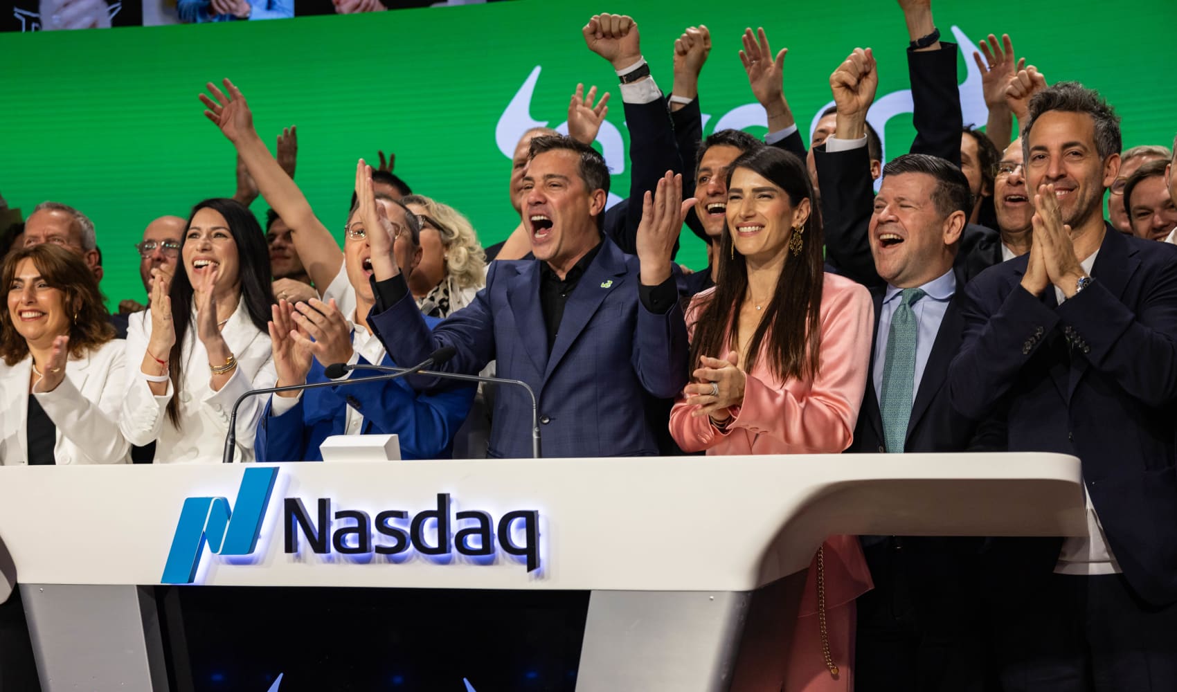 Yoni Assia, co-founder and CEO of eToro Group Ltd., center, and Ronen Assia, co-founder of eToro Group Ltd., center left, ring the opening bell during the company’s initial public offering at the Nasdaq MarketSite in New York, May 15, 2025.