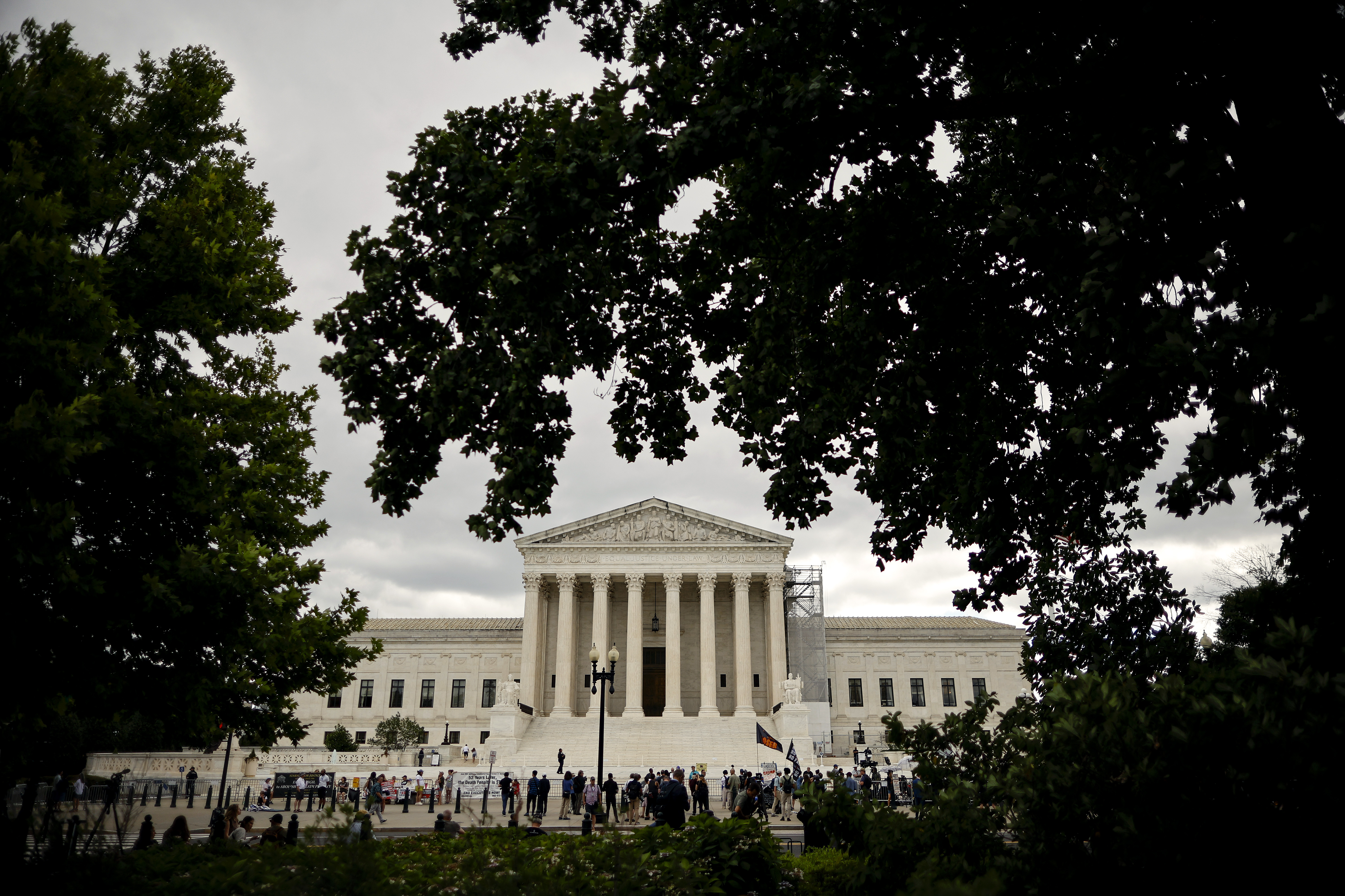 WASHINGTON, DC – JULY 01: Demonstrators, members of the media, and bystanders gather outside the U.S. Supreme Court on July 01, 2024 in Washington, DC. The Supreme Court released its ruling in Trump v. United States, stating that a former president has absolute immunity for official acts but that immunity is not extended for unofficial acts.